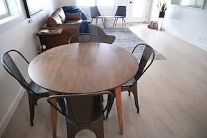 Circular solid wood dining table with seating for four