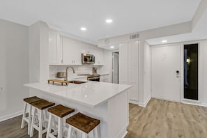 Kitchen/ - Who wouldn't want to sit at this bright and large counter and have breakfast or snack?!