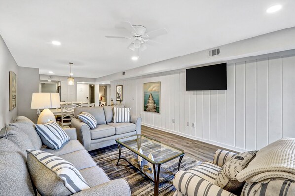 Living Room - Plenty of seating in this completely renovated villa. Wall mounted flat screen TV for movie nights! It also includes a queen sized sleeper sofa for those extra guests.