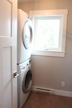 Full size washer and dryer in separate laundry room within suite.