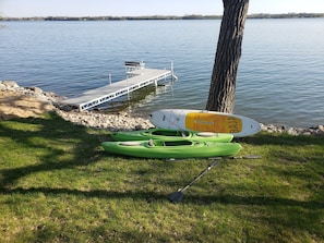 2 kayaks and a paddleboard