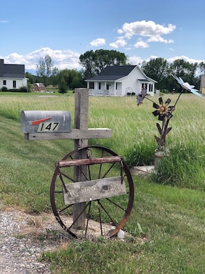 The number on the mailbox is 147 and iron flowers say, stop you are here!