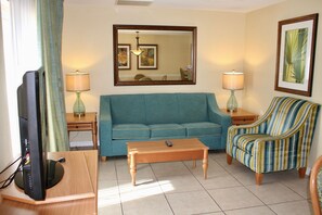 Ground floor living room with a sleepers sofa to accommodate 2 guests. Private patio access