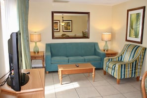 Ground floor living room with a sleepers sofa to accommodate 2 guests. Private patio access
