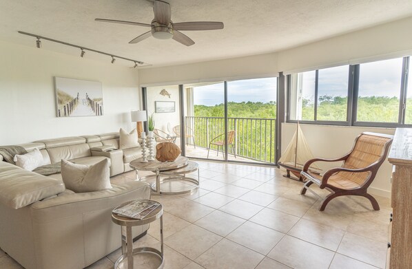 Living room showing the balcony & wall to wall windows