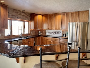 Large beautiful kitchen with dark Granit and Mahogany cabinets. 