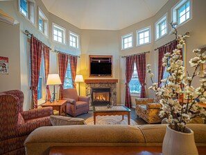 Living area with gas fireplace, sofa bed, and large smart LCD TV