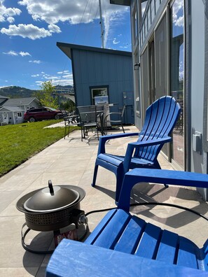 Large patio with BBQ, Fire Pit, Seating.