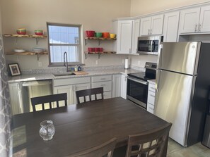 Dining room table with easy access to kitchen and grilling area. 