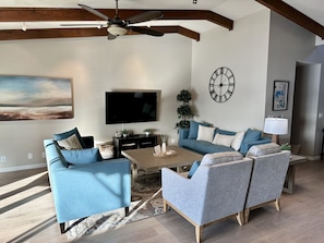 Living room with 65” smart TV.  Comfortable seating for 8.