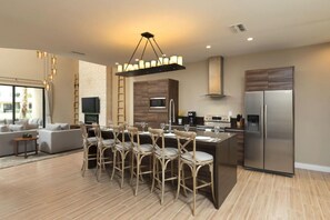 Fully equipped kitchen with a microwave, stove, oven and fridge. All utensils, plates and glasses are provided