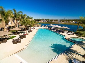 Large swimming pool with loungers and umbrellas