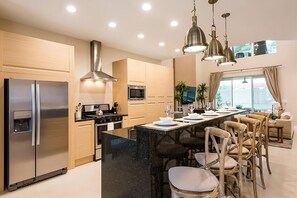 Fully equipped kitchen with a microwave, stove, oven and fridge. All utensils, plates and glasses are provided