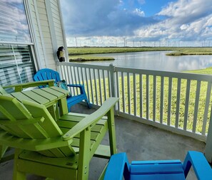 Private patio overlooks saltwater fishing pond, coastal birds & beach grasslands