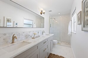 Our upstairs ensuite boasts a double vanity and marble details throughout.