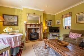 Garden Cottage, East Rudham: Sitting room with plenty of comfortable seating and a wood burning stove
