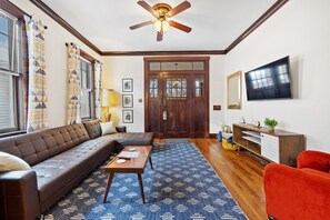 Spacious living Room with Craftsman columns, built in bookcase, and Large Couch!