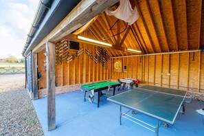 Covered outdoor games area offering table tennis, pool and darts