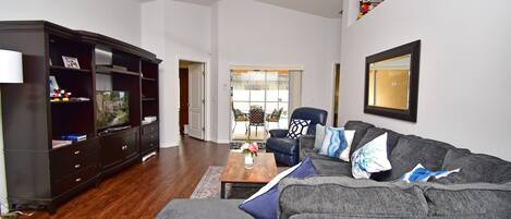 Comfortable lounge area with patio doors to pool area