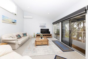 Lounge room that leads onto balcony and al fresco dining overlooking Wallis Lake