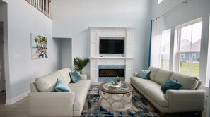 Living area with an electric fireplace and 55"tv