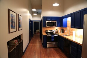 Kitchen looking toward hallway with bedrooms and bathrooms