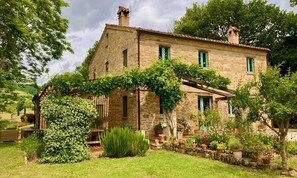 The main house with half shaded terrace facing south