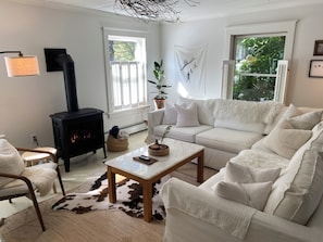 Living and dining area with gas fireplace and record player. 