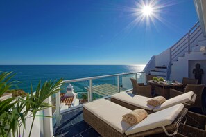 First floor balcony with sun loungers & dinning area