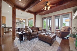 Living-room with double french doors leading out to a large covered patio.