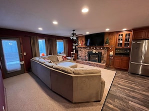 Cozy living room to relax and unwind by the fireplace after a long day outside 