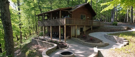 The Retreat at Pine Haven extends the living area with incredible stonework that includes an enormous fire pit and patio. 