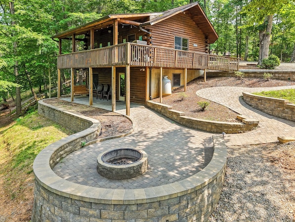The Retreat at Pine Haven extends the living area with incredible stonework that includes an enormous fire pit and patio.