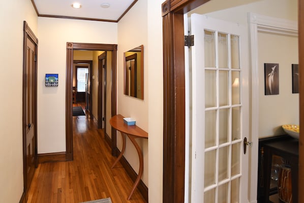 Entrance foyer in apartment, with French doors to living room.