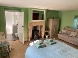 Green room with wood-burning stove and en suite bathroom