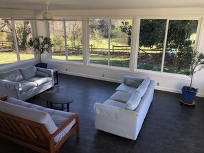 Sunroom features both sunrise and sunset via 3 walls of giant windows.