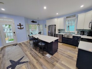 Newly renovated, modern, open-concept kitchen, with large island.