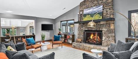 Great Room With Floor To Ceiling Stone Wood Burning Fire Place