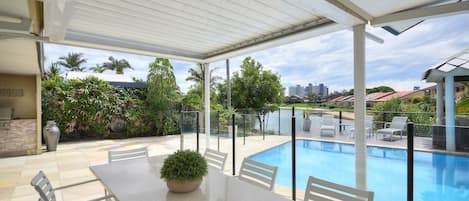 Alfresco Dining by the pool overlooking the canal and the skyline of Broadbeach