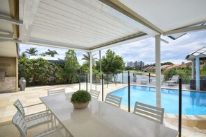 Alfresco Dining by the pool overlooking the canal and the skyline of Broadbeach