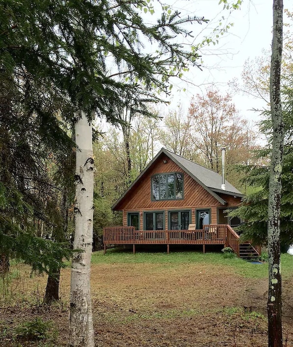 Front view of cabin from the fire pit by the beach.