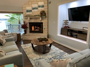 Living room with remote start gas fireplace, smart TV with Bluray/DVD player.