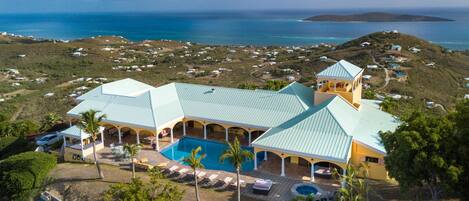 An aerial view of the house overlooking the valley below. 