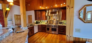 Main kitchen on upper level, GE Monogram oven, ice maker, Keurig & coffee maker.
