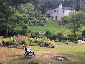 Peaceful back yard overlook the canal, well shaded, Adirondack chairs, fire pit