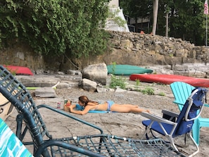 The stone beach for swimming, boating and reading on a summer day