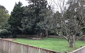 A large, flat, fenced-in backyard.
