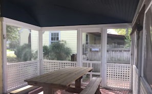 Screened-in patio with full-size picnic table.