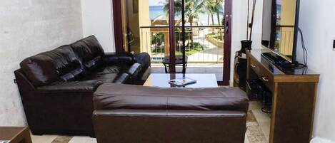 Living room with sea and pool view.