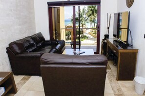 Living room with sea and pool view.